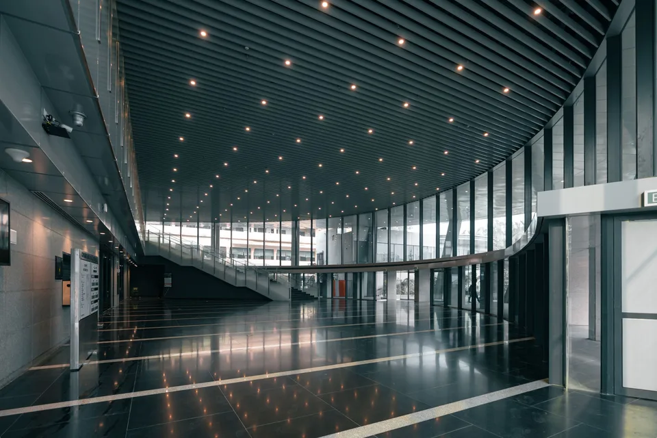 Curved glazing along a large interior hallway