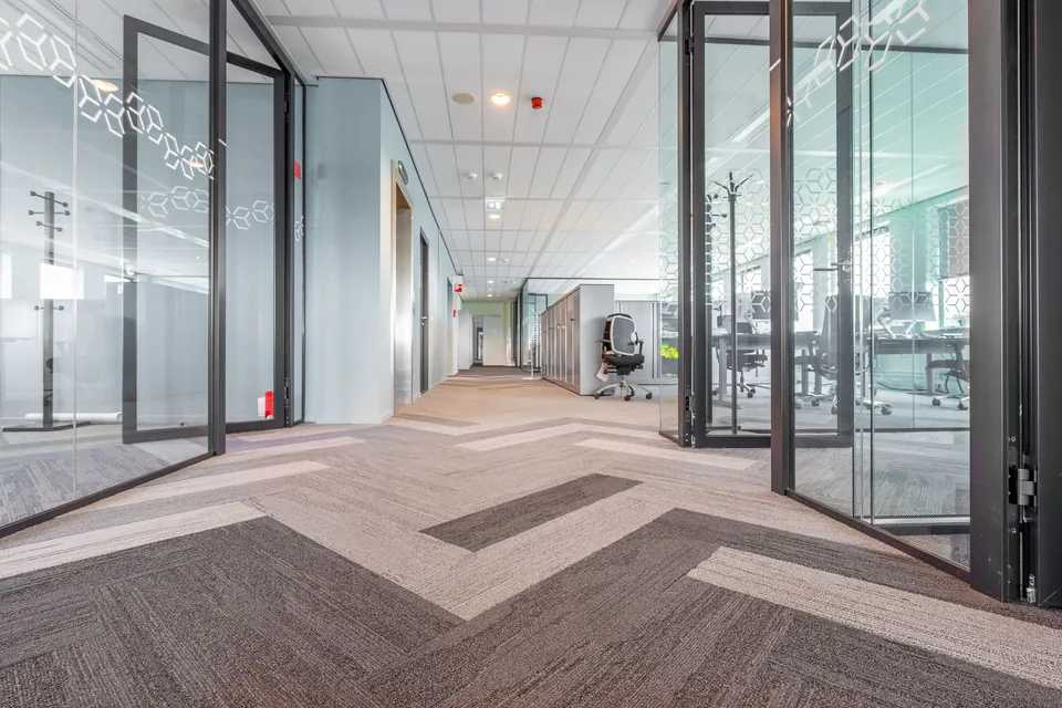 Office corridor with framed glazed partitions