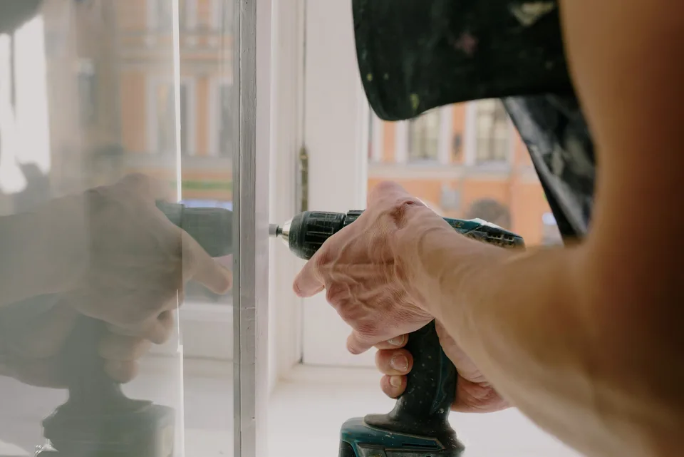 Close-up of a worker adjusting window hardware