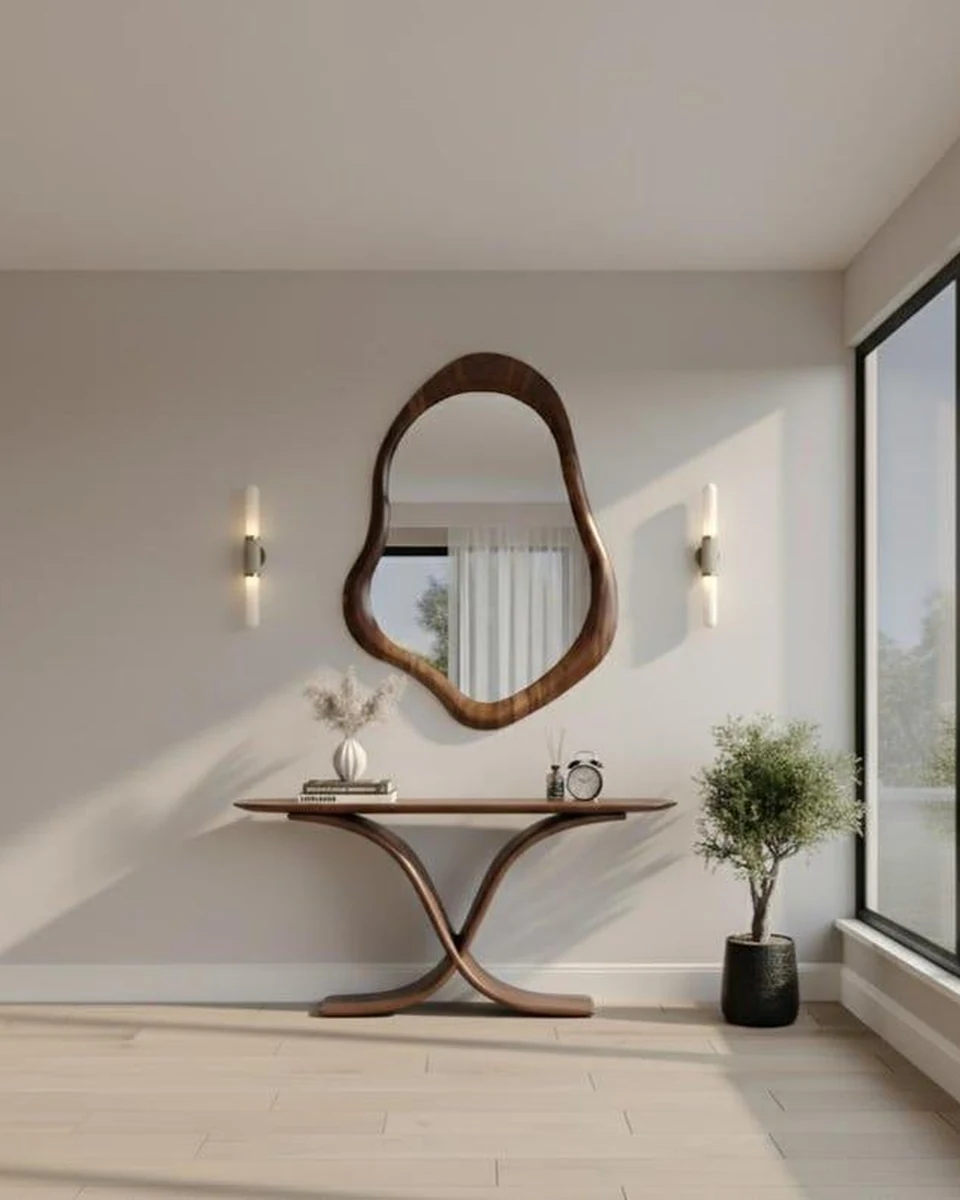 Designer mirror above a dressing console in a bright interior