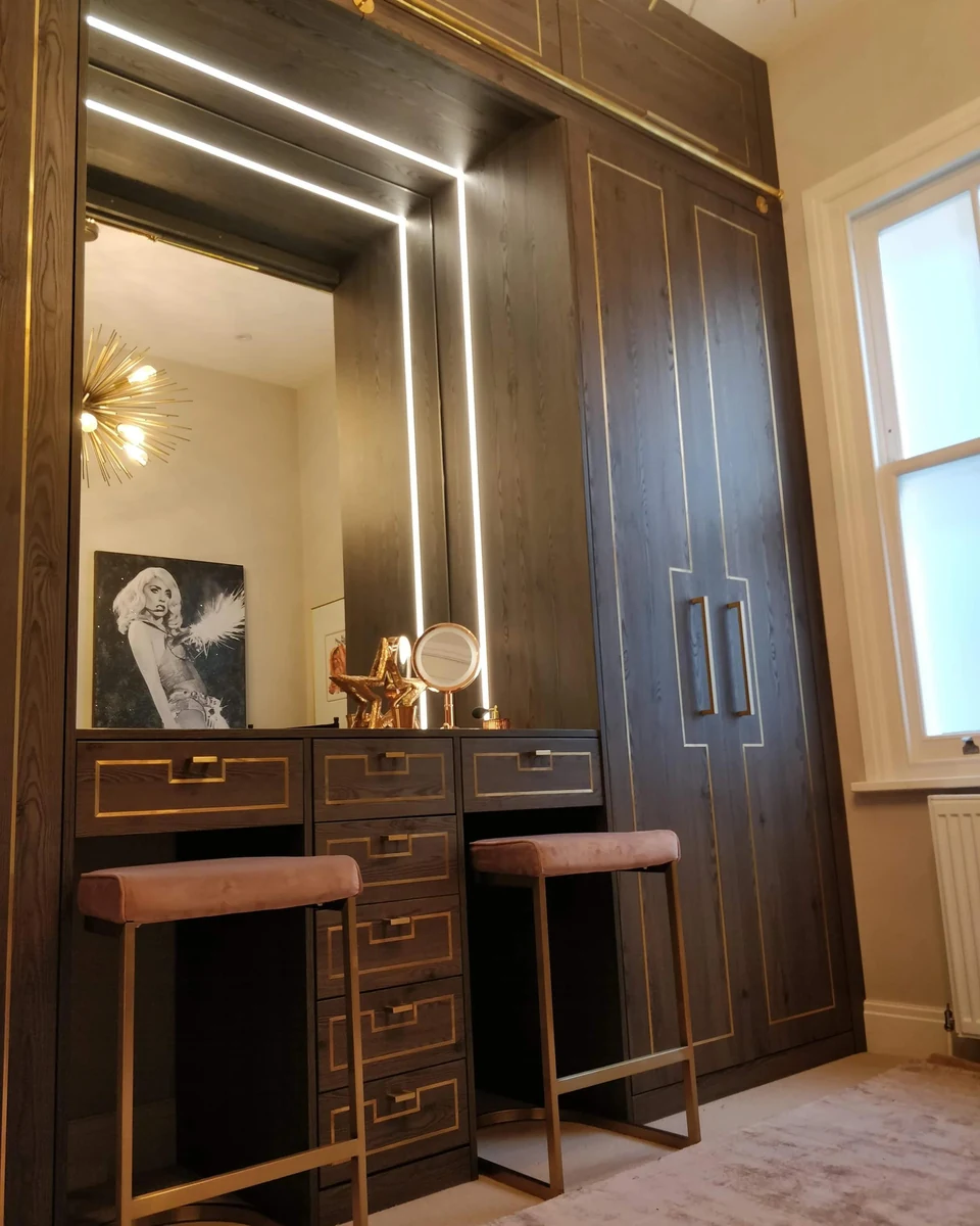 Tall illuminated dressing mirror fitted beside a wardrobe